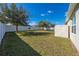 Spacious backyard featuring a well-maintained lawn, mature trees, storage shed, and a white privacy fence at 1470 Silverado Flats St, Kissimmee, FL 34744