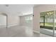 Living room featuring tile flooring, neutral paint and sliding glass doors to the patio at 1470 Silverado Flats St, Kissimmee, FL 34744