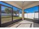 Screened lanai offers views of fenced backyard with beautiful sun and sky at 1470 Silverado Flats St, Kissimmee, FL 34744