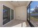 Screened porch with sliding glass doors and wood-look tile floor at 1470 Silverado Flats St, Kissimmee, FL 34744