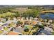 Aerial view of houses in a community by a lake with conservation at 15925 St Clair St, Clermont, FL 34714