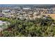 Aerial view showcasing a neighborhood with houses near a lake at 15925 St Clair St, Clermont, FL 34714