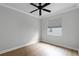 Bright bedroom with ceiling fan and wood-look flooring at 15925 St Clair St, Clermont, FL 34714