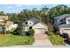 Single-Gathering home with two-car garage, manicured lawn, and brick driveway at 15925 St Clair St, Clermont, FL 34714