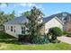 Side view of a single-story house with light-beige siding and a gray roof at 15925 St Clair St, Clermont, FL 34714