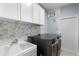 Bright laundry room with hexagon tile and a utility sink at 15925 St Clair St, Clermont, FL 34714