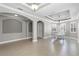 Elegant living room featuring high ceilings, neutral walls, and a white baby grand piano at 15925 St Clair St, Clermont, FL 34714