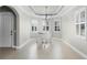 Bright living room featuring a white piano and elegant chandelier at 15925 St Clair St, Clermont, FL 34714