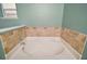 Bathroom with tile surround and oval tub at 1603 S Mary St, Eustis, FL 32726