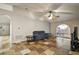 Living Room with gray couch, tiled floors, and a large window at 1603 S Mary St, Eustis, FL 32726