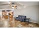 Living Room with gray couch, kitchen view, and tiled floors at 1603 S Mary St, Eustis, FL 32726