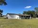 Home exterior view of the home's fenced in backyard and well maintained lawn at 1705 Underwood Ave, St Cloud, FL 34771