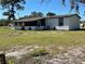 View of backyard and the home's screened in patio, perfect for outdoor living at 1705 Underwood Ave, St Cloud, FL 34771