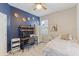 Bedroom with a desk, blue accent wall, and full-size bed at 1860 Black Maple Pl, Ocoee, FL 34761