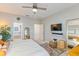 Main bedroom with ensuite bathroom, ceiling fan, and large TV at 1860 Black Maple Pl, Ocoee, FL 34761