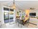 Bright dining area with farmhouse table and access to backyard patio at 1860 Black Maple Pl, Ocoee, FL 34761