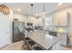 Modern kitchen boasts ample counter space, stainless steel appliances, and an island at 1860 Black Maple Pl, Ocoee, FL 34761