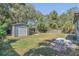 Expansive backyard showcasing a storage shed, lush lawn, and fire pit for outdoor enjoyment at 2106 Cordova Dr, Sanford, FL 32771