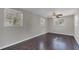 Spacious bedroom featuring hardwood floors, neutral walls, and plenty of natural light from multiple windows at 2106 Cordova Dr, Sanford, FL 32771