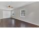 Neutral bedroom featuring hardwood floors, ceiling fan, and bright natural light at 2106 Cordova Dr, Sanford, FL 32771