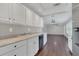 Well-lit kitchen with granite counters, stainless steel dishwasher, with view into the living room at 2106 Cordova Dr, Sanford, FL 32771