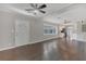 Open living space with hardwood floors, ceiling fan, and view into the kitchen at 2106 Cordova Dr, Sanford, FL 32771