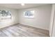 Spacious bedroom featuring light walls and wood-look floors at 2120 Waitman Ave, Leesburg, FL 34748