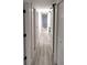 Clean hallway with white doors and light grey flooring at 2120 Waitman Ave, Leesburg, FL 34748