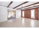 Bright dining room with exposed beams, brick accent wall, and tile flooring at 2247 King Edwards Ct, Winter Park, FL 32792