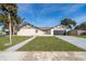 Two-car garage and nicely landscaped front yard with a walkway leading to the front door at 2247 King Edwards Ct, Winter Park, FL 32792