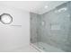 Walk-in shower with grey tile and glass enclosure at 2247 King Edwards Ct, Winter Park, FL 32792