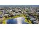 Aerial view of a residential neighborhood with houses and a lake at 2446 Leaning Pine Ln, Oviedo, FL 32765