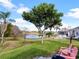 Backyard with lake view and pink chairs at 2446 Leaning Pine Ln, Oviedo, FL 32765