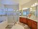 Large bathroom with double vanity, a soaking tub, and a walk-in shower at 2446 Leaning Pine Ln, Oviedo, FL 32765