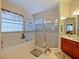 Bathroom with corner shower, a soaking tub, and a double vanity at 2446 Leaning Pine Ln, Oviedo, FL 32765