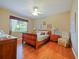 Bright bedroom with wood flooring, a wooden sleigh bed, and a ceiling fan at 2446 Leaning Pine Ln, Oviedo, FL 32765