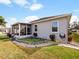 House exterior featuring a screened porch, garden, and grassy yard at 2446 Leaning Pine Ln, Oviedo, FL 32765