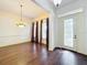 Formal dining room with hardwood floors, chandelier, and large windows at 2511 Madron Ct, Orlando, FL 32806