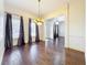 Formal dining room with hardwood floors, chandelier, and large windows at 2511 Madron Ct, Orlando, FL 32806