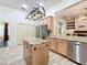 Island kitchen with granite countertops and wood cabinets at 2511 Madron Ct, Orlando, FL 32806