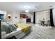 Open living space featuring wood-look tile floors, a bed, dining area, and kitchen at 2511 Madron Ct, Orlando, FL 32806