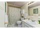 Charming bathroom with floral shower curtain and white vanity at 2823 Cady Way, Winter Park, FL 32792