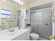 Bathroom with walk-in shower, modern vanity, and decorative mirror and lighting at 2823 Cady Way, Winter Park, FL 32792