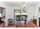 Dining room with hardwood floors, wooden table, and access to screened patio at 2823 Cady Way, Winter Park, FL 32792