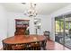 Dining room with hardwood floors, wooden table, and a crystal chandelier at 2823 Cady Way, Winter Park, FL 32792