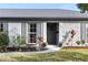 Charming home featuring a gray brick exterior, a welcoming front door, and professional landscaping at 2823 Cady Way, Winter Park, FL 32792