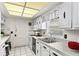 Bright kitchen features white cabinets, stainless steel appliances, and double basin sink under natural light at 2823 Cady Way, Winter Park, FL 32792
