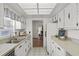 Efficient galley kitchen with bright natural lighting, double basin sink, and bright white cabinets at 2823 Cady Way, Winter Park, FL 32792