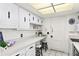Efficient kitchen featuring ample counter space, white cabinetry, and convenient breakfast bar seating at 2823 Cady Way, Winter Park, FL 32792