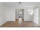 Bright living room with wood floors, a large window, and views to the bedroom at 2823 Cady Way, Winter Park, FL 32792